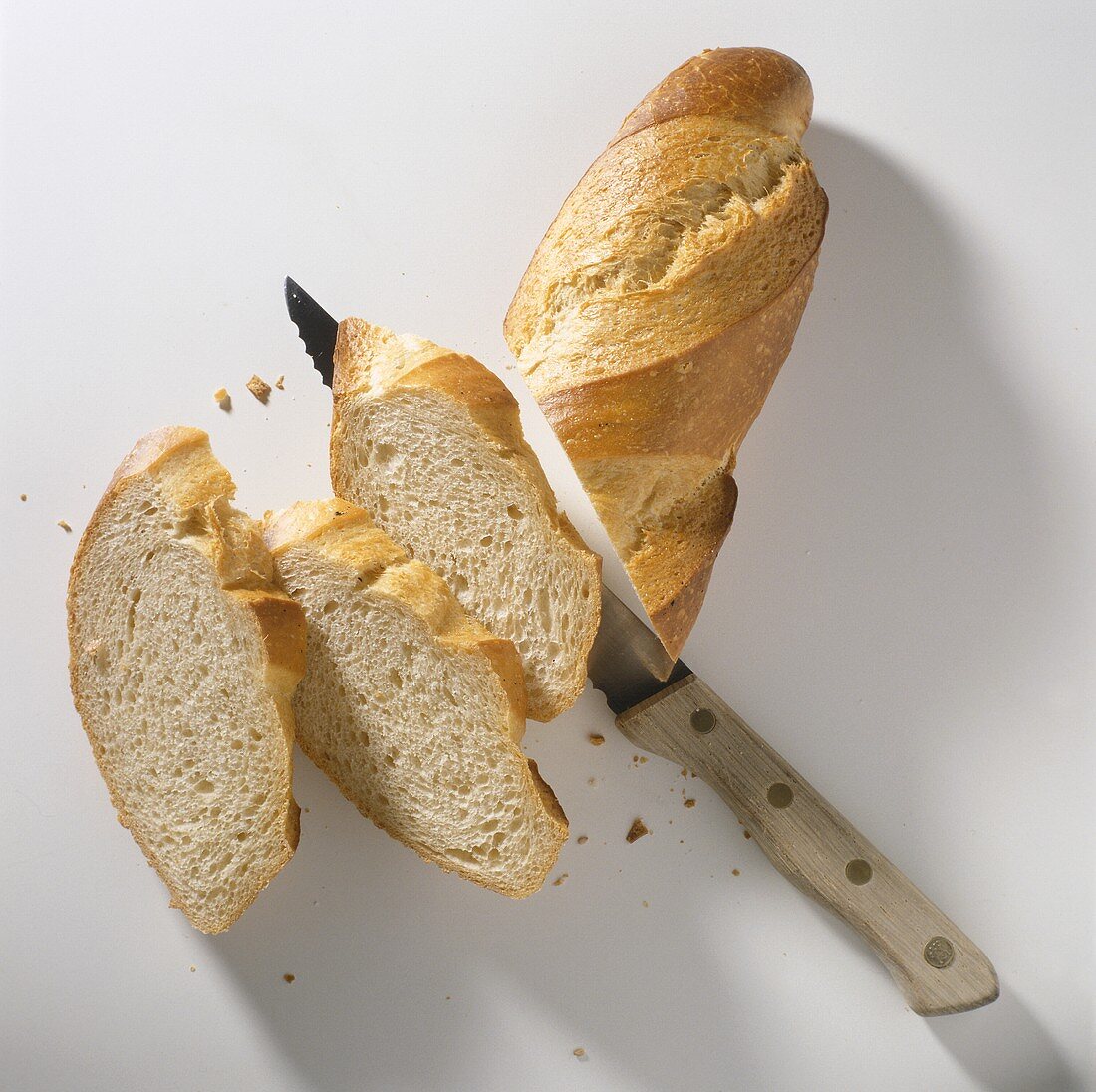 A French bread being sliced