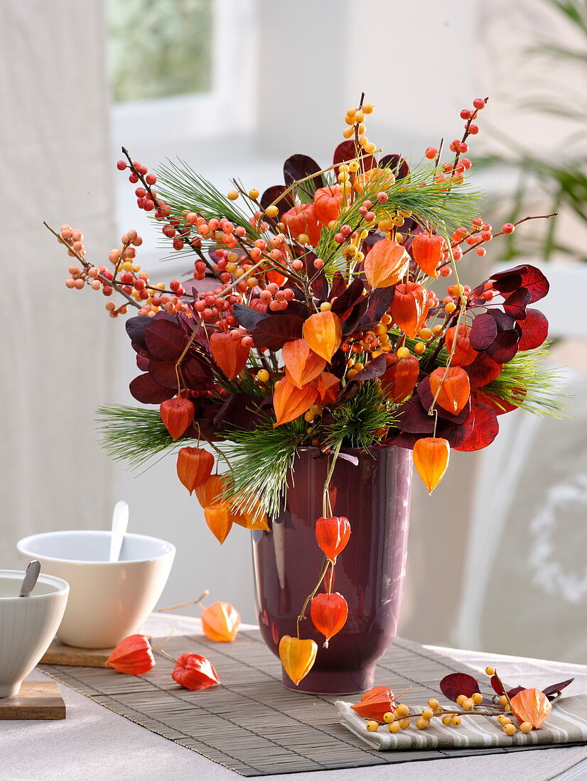 Autumn bouquet of leaves and fruits, Ilex (winter berry)
