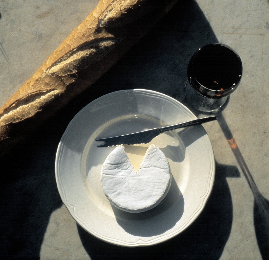 Camembert on a Plate with Baguette; Red Wine