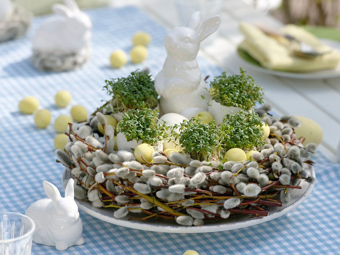 Easter table decoration with cress eggs and pussy willow