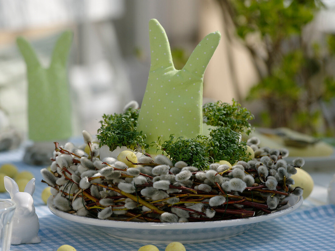Easter table decoration with cress eggs and willow catkins