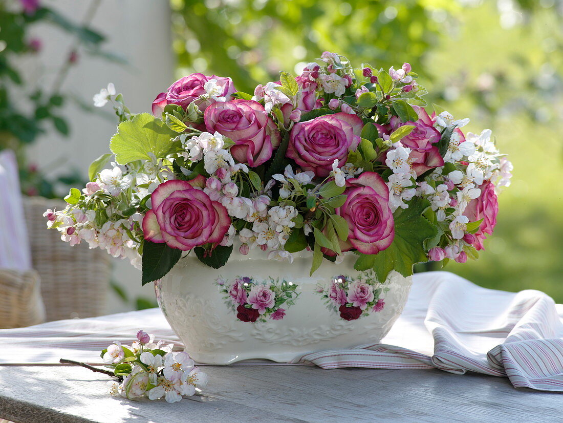 Bouquet of Rosa 'Variance' (noble roses), white with pink border and Malus