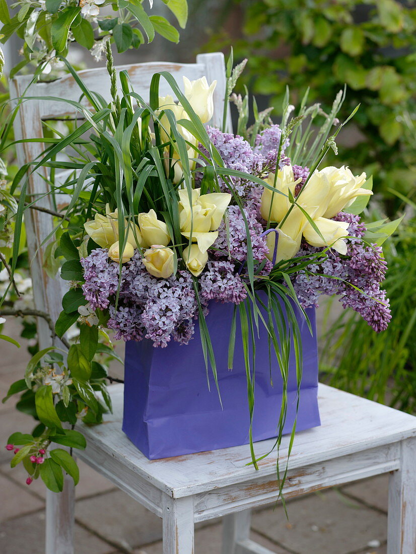 Fragrant bouquet of syringa (lilac), tulipa (tulips) and grasses