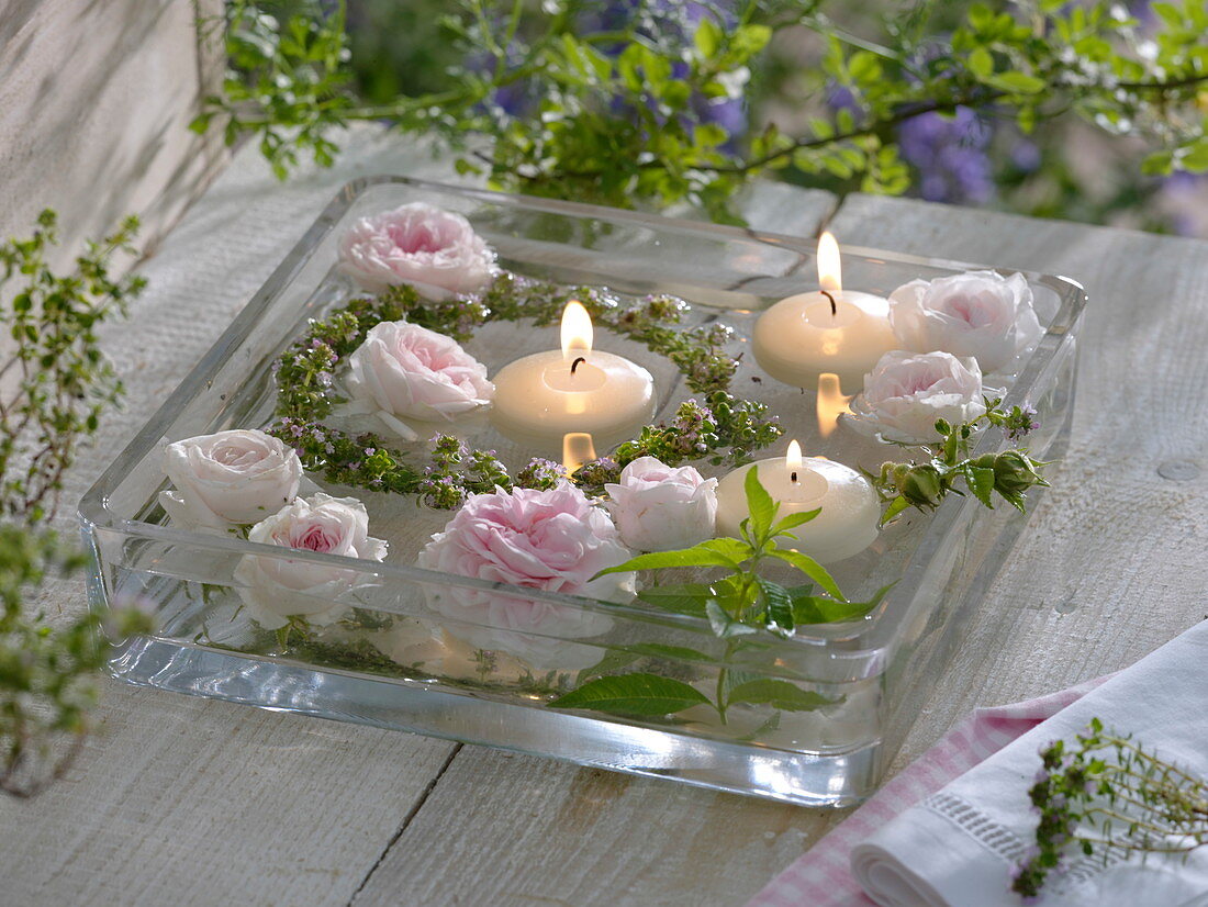 Rose blossoms and herb wreath in water
