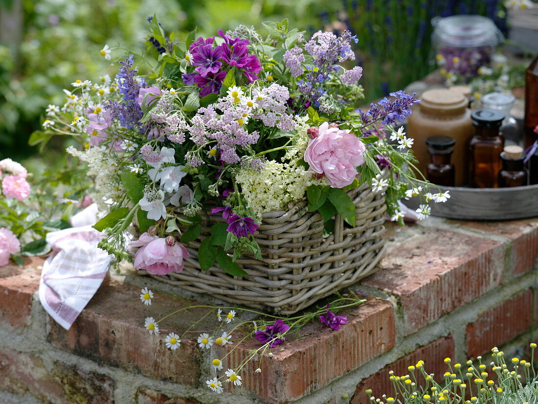 Bouquet of herbs in a basket placed on a wall