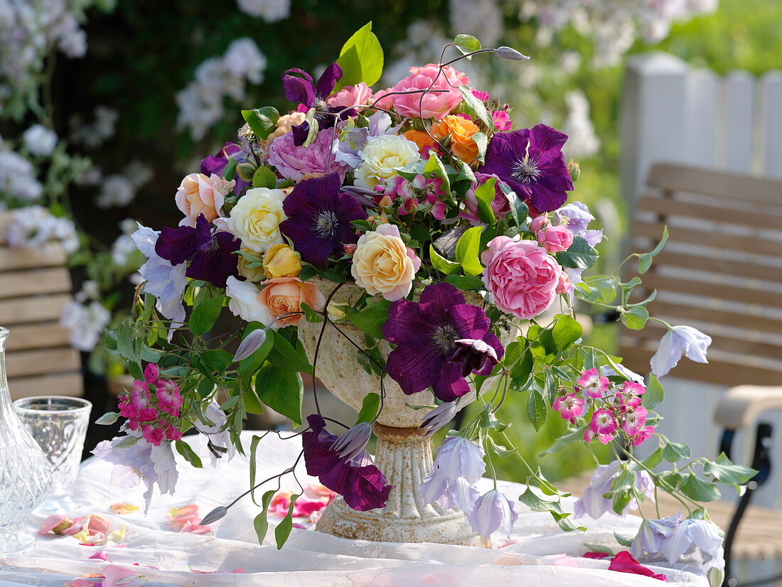 Romantic arrangement made of roses and clematis (clematis)