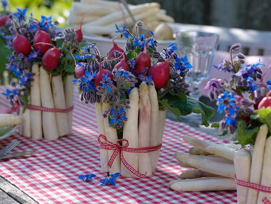 Table decoration with asparagus, radishes and borage