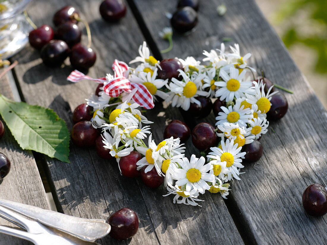 Summer table decoration with sweet cherries and camomile