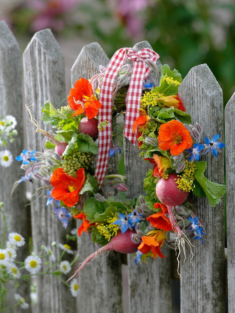 Small wreath of edible flowers, herbs and radishes