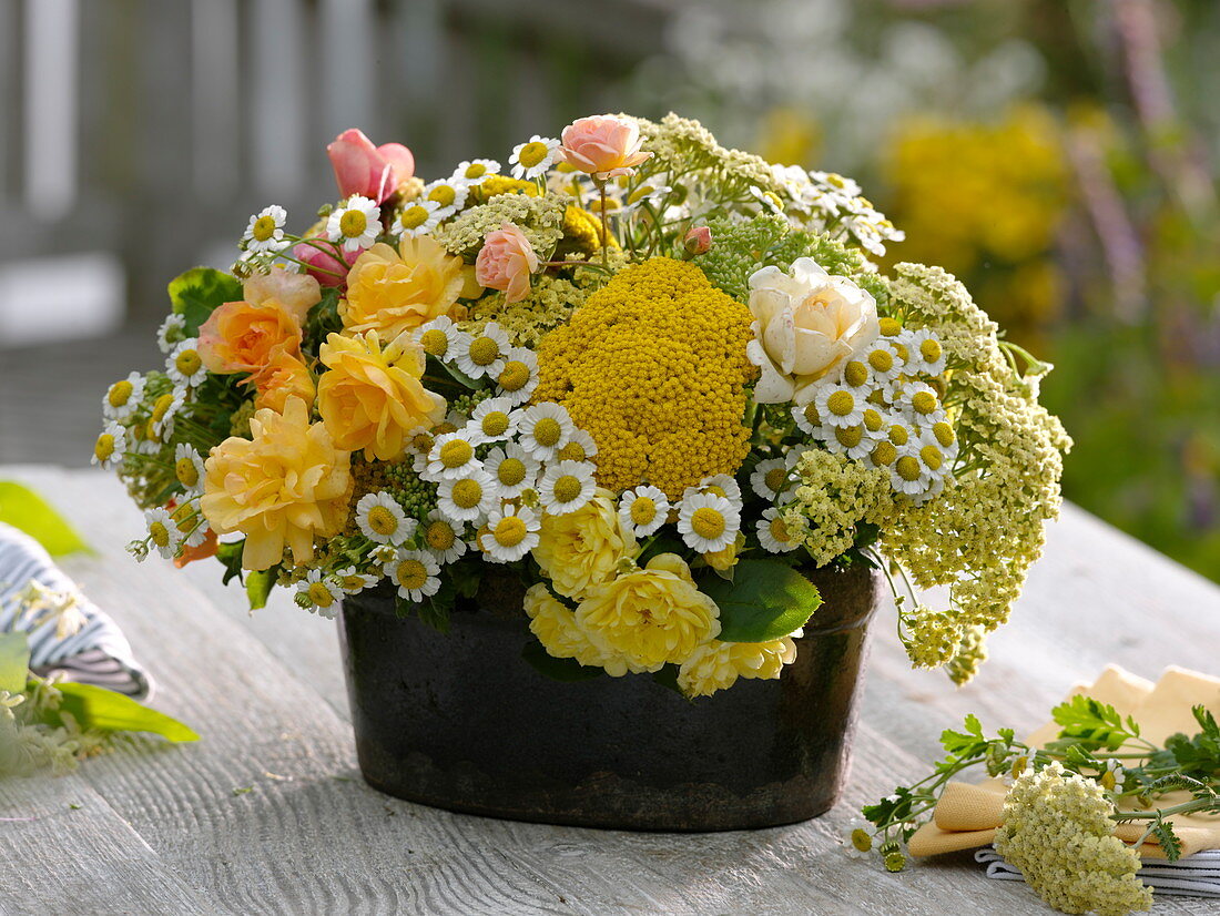 White-yellow flower arrangement in jardiniere