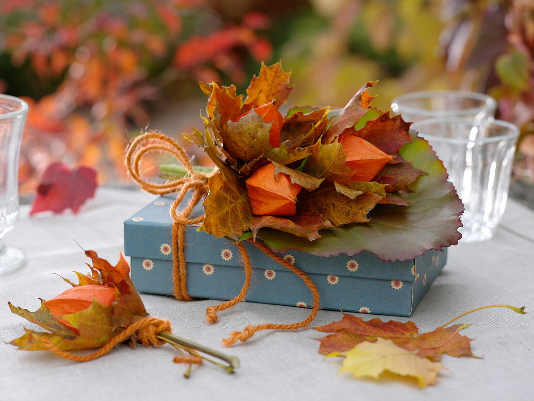 Gift decorated with physalis (lantern flower), Acer leaves