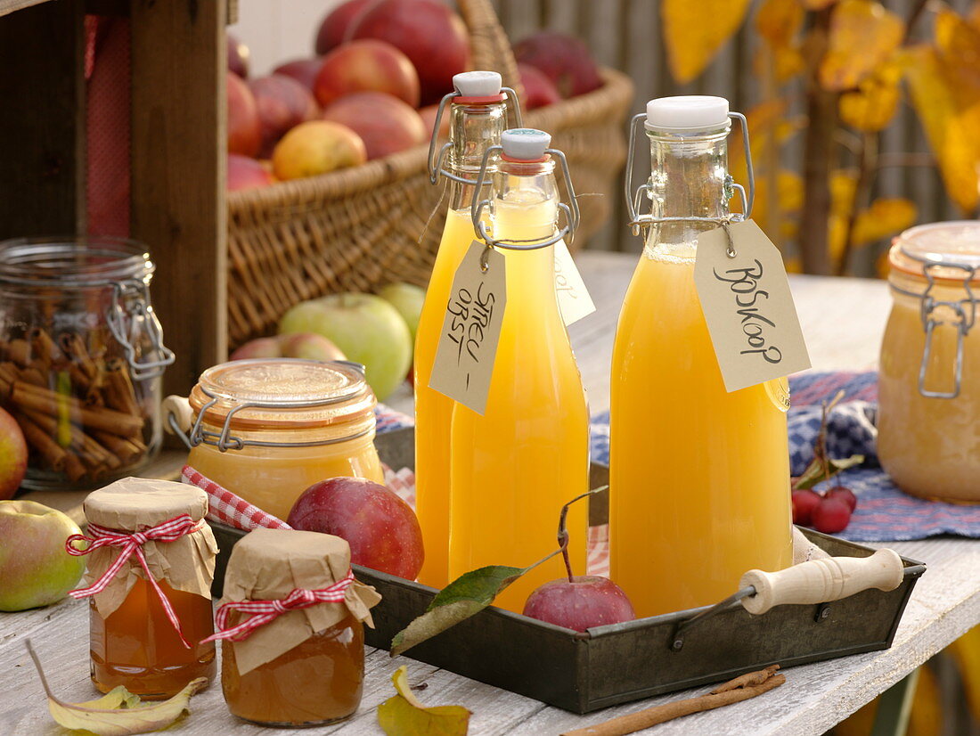 Bottles of freshly squeezed apple juice, jars of jelly and apple sauce