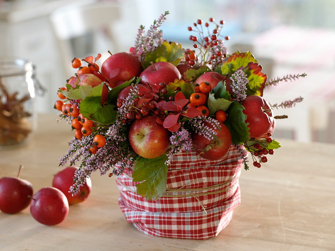 Autumn bouquet of apples (Malus), rose (rosehips), Calluna