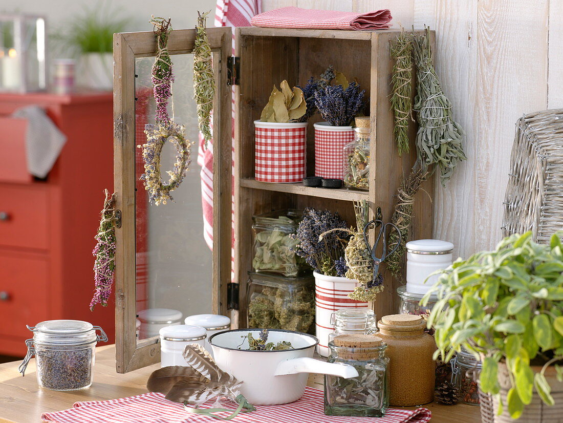 Small cupboard with dried herbs and incense bundles