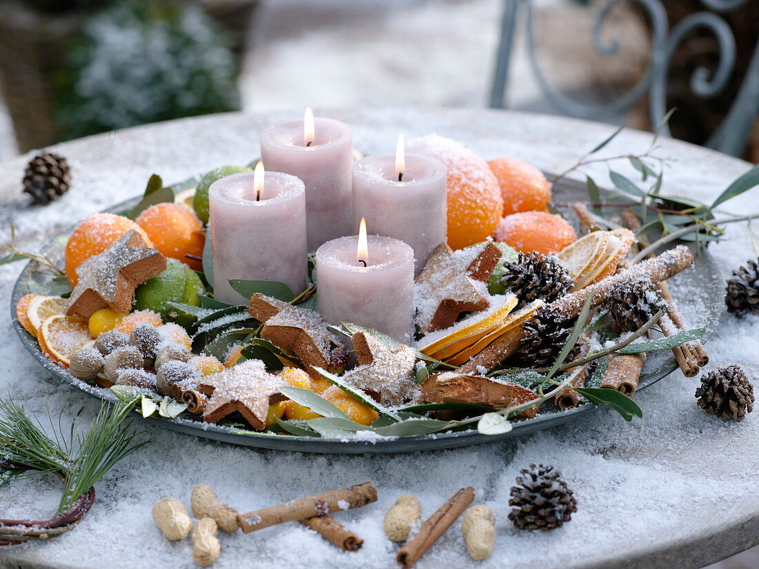 Plate with 4 candles, oranges, orange slices, limes, and kumquats