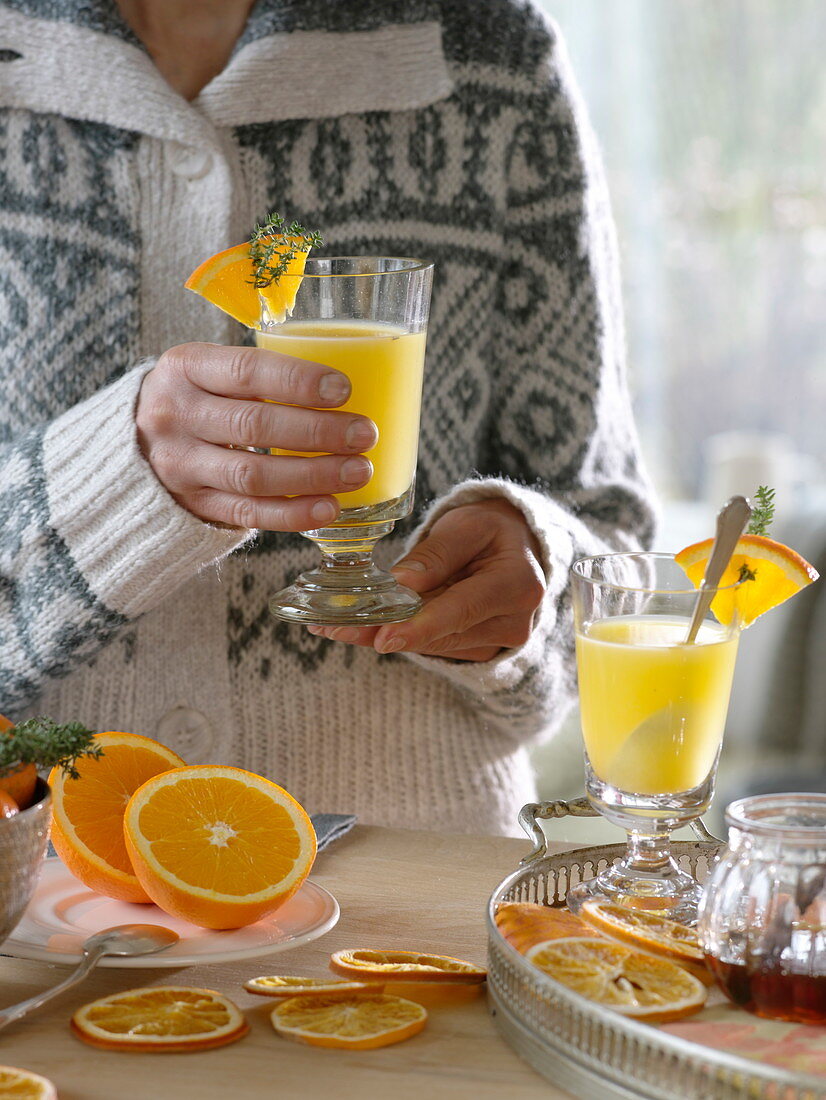 Hot orange juice in coarse glasses, orange pieces