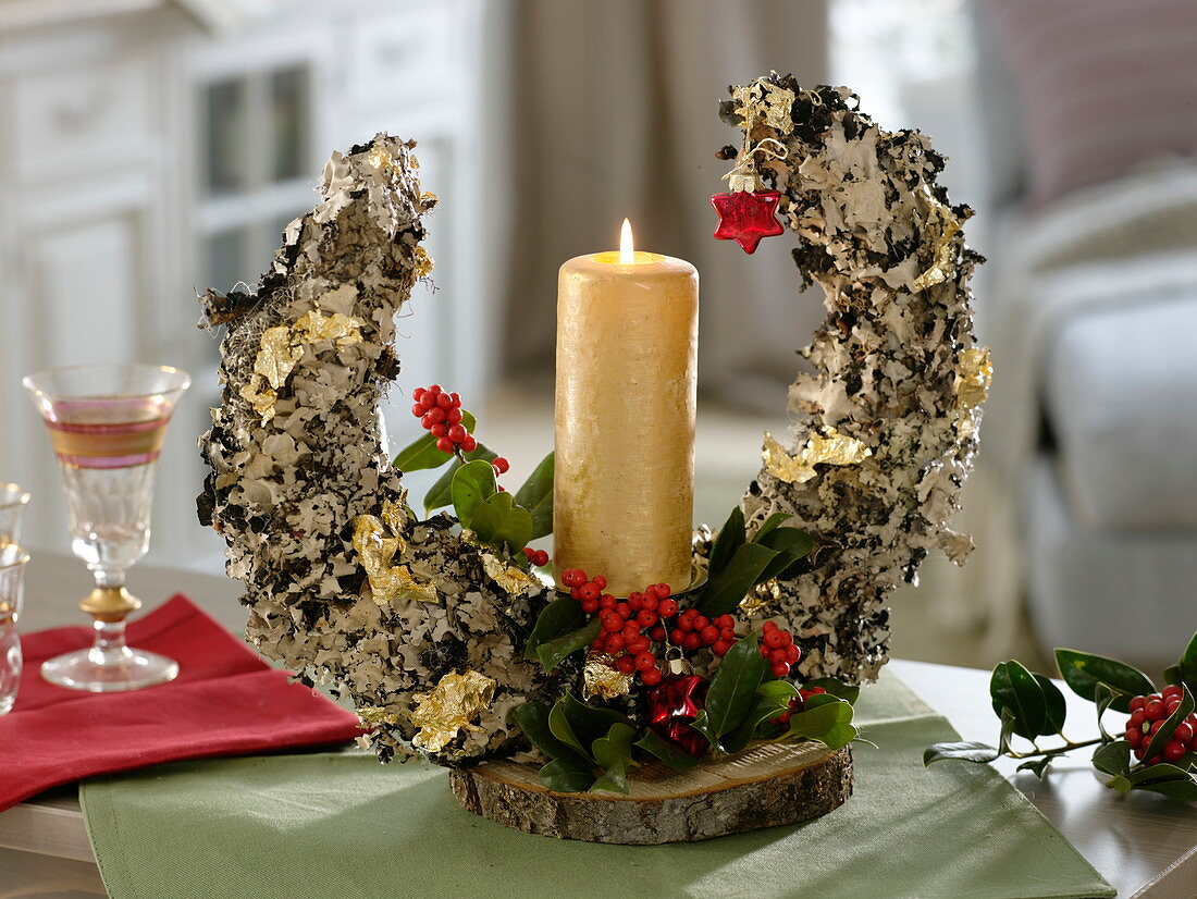 Crescent moon covered with lichen as candle decoration with Ilex (holly)