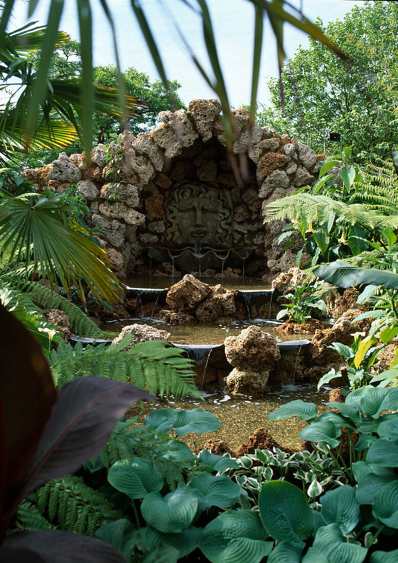 Tufa grotto with water feature, small waterfalls, Hosta (Funkie)