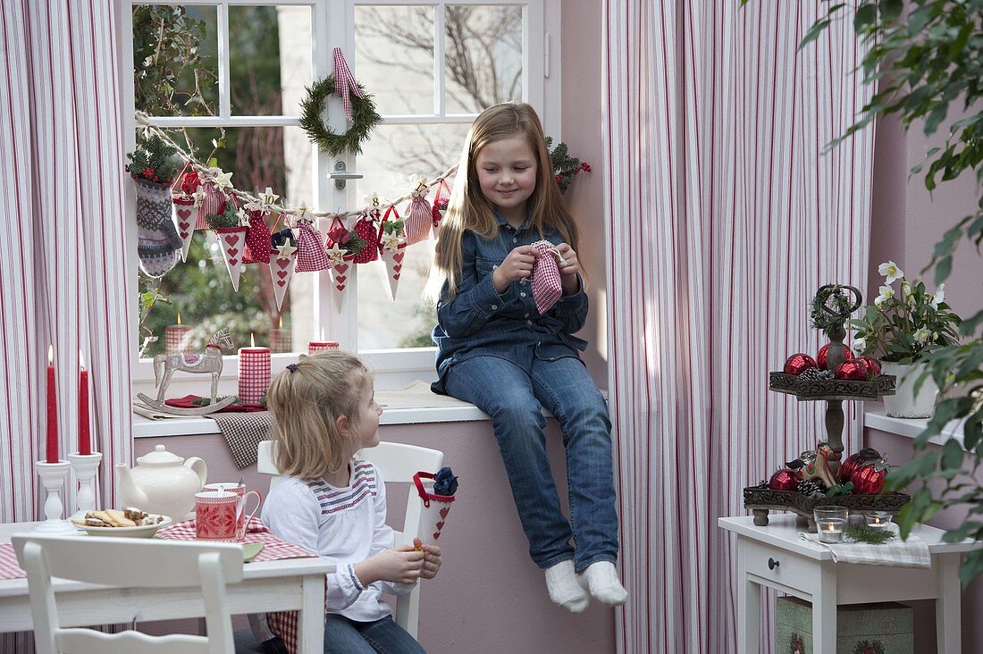 Girl with Advent calendar at window