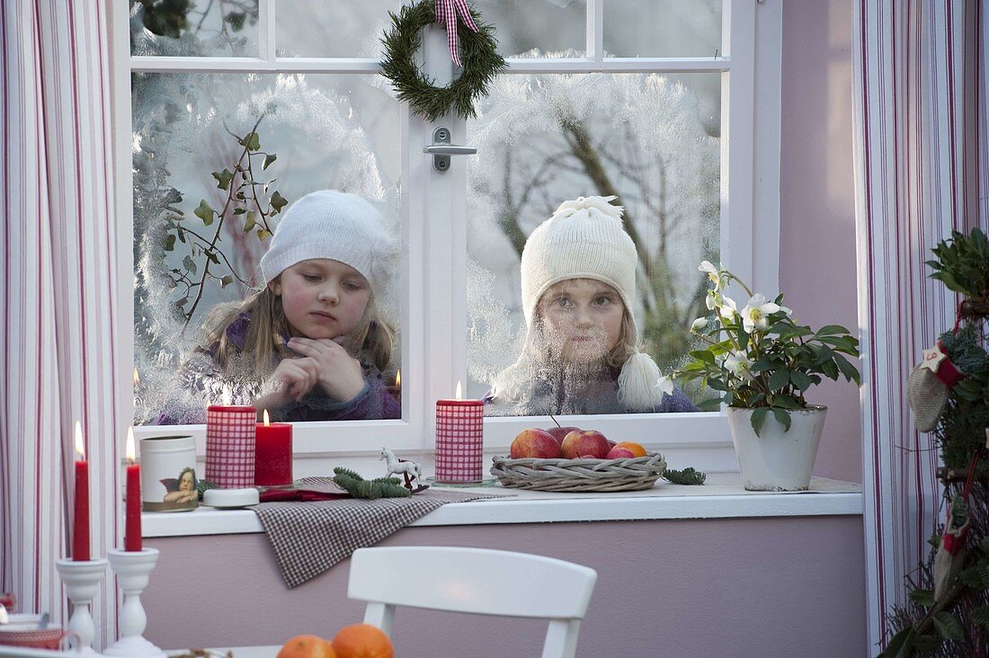 Girls looking into the room from outside