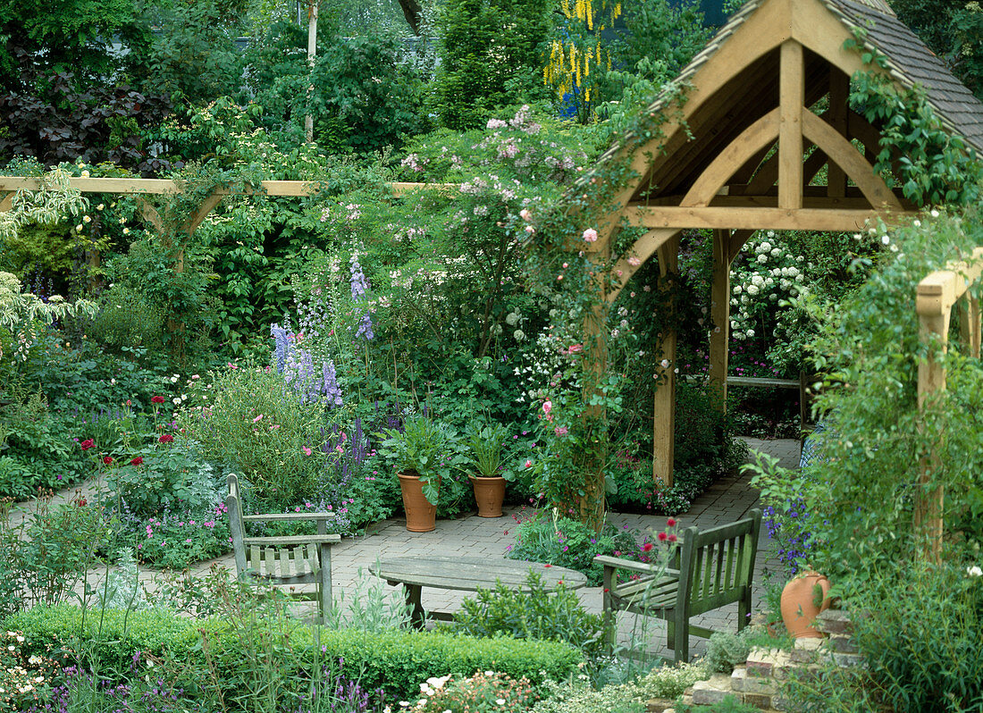 Seat in the garden with wooden house