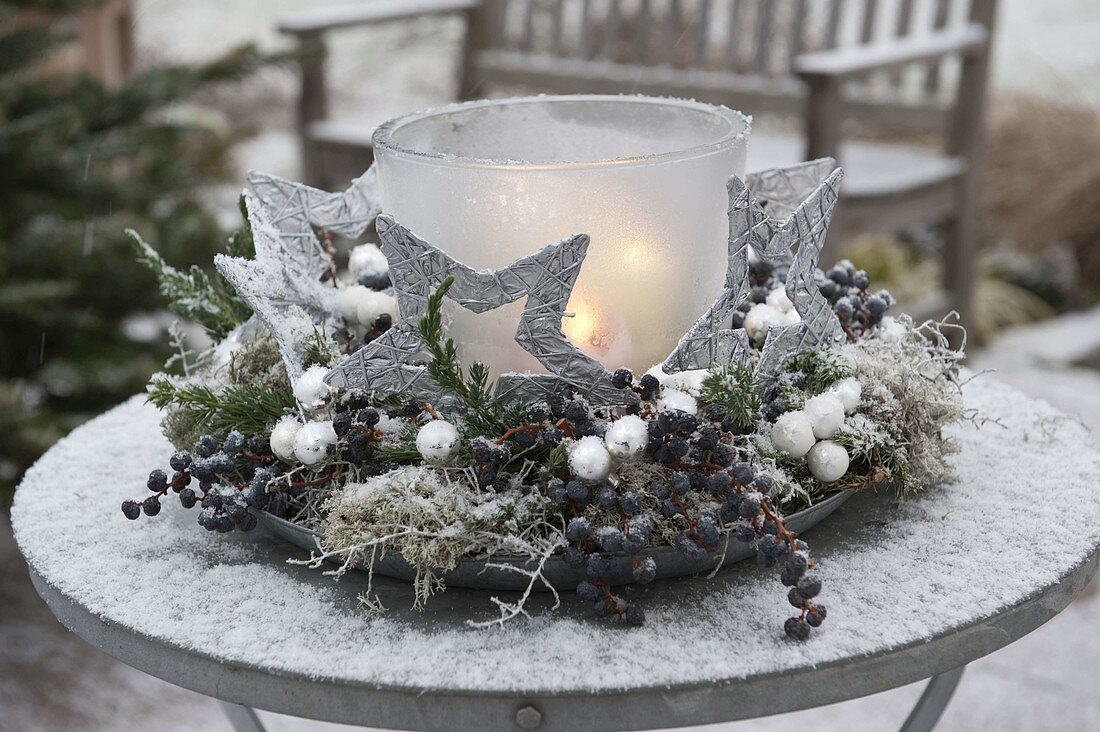 Frozen lantern in wreath of Juniperus (juniper)