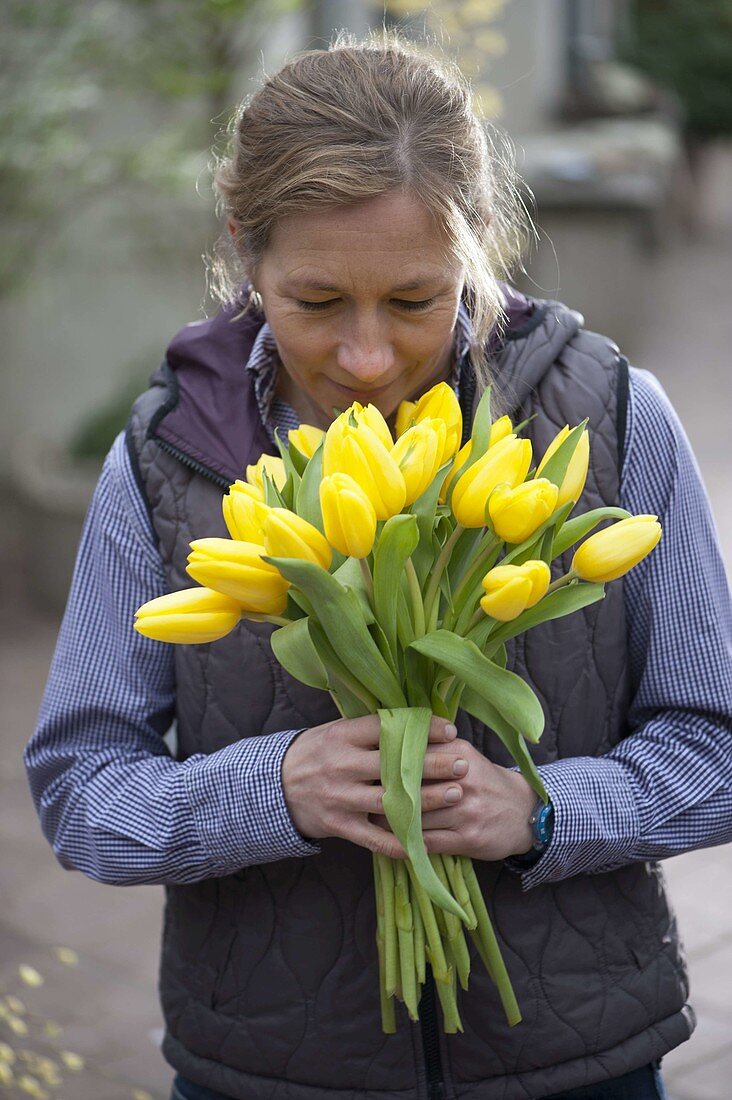 Woman with yellow tulip bouquet