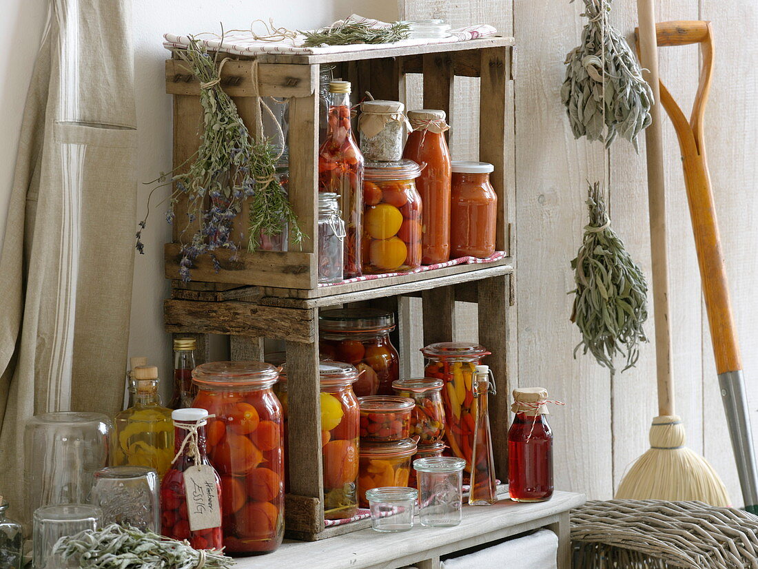 Preserved tomatoes, peppers, vinegar and herbs in self-made shelf