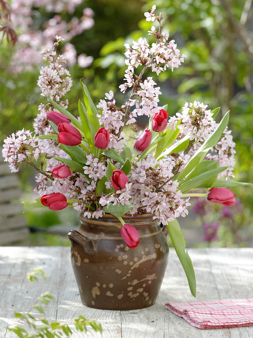 Simple bouquet of Prunus (ornamental cherries) and Tulipa (tulips)