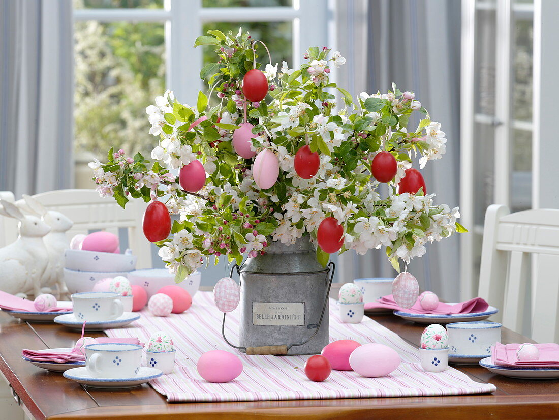 Easter table decoration with a bouquet of apple blossom branches