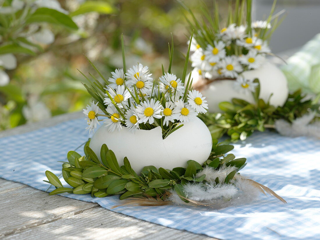 Ostrich egg as a vase in a Buxus (Box) wreath with feathers