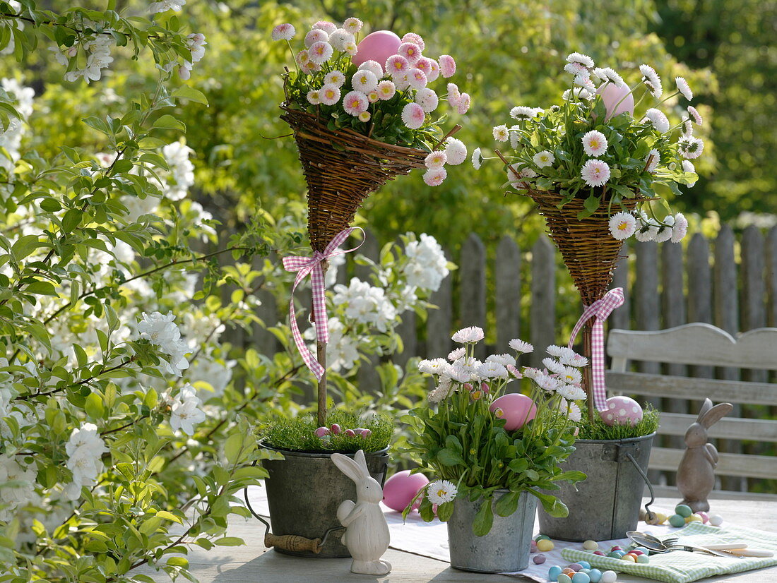 Self made wicker baskets pinned on sticks in metal pots