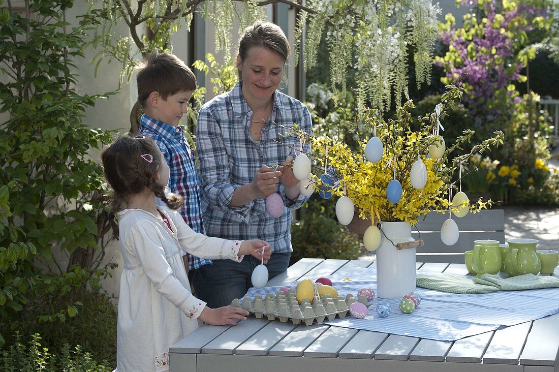 Woman with children decorating Easter bouquet