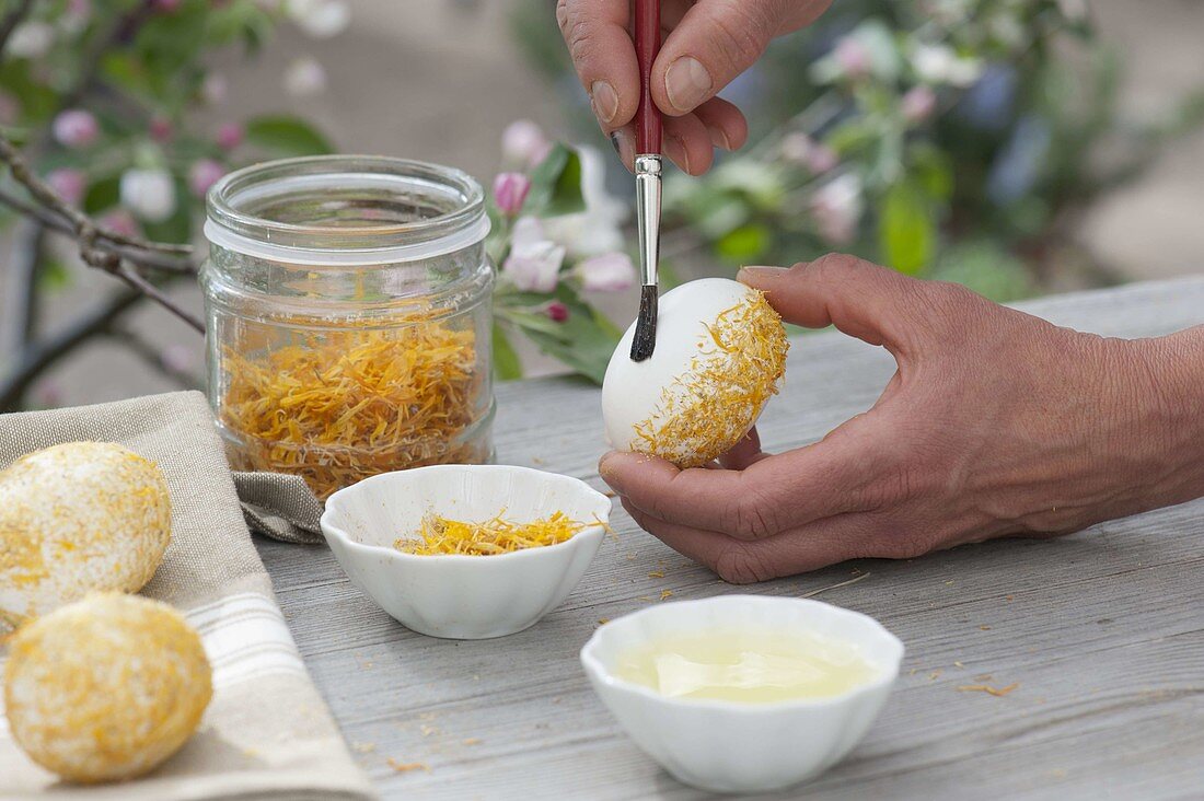 Sticking crushed flowers to easter eggs