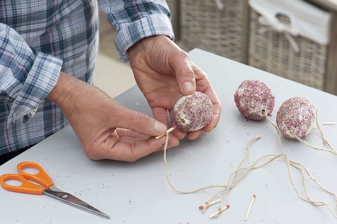 Sticking crushed flowers to easter eggs