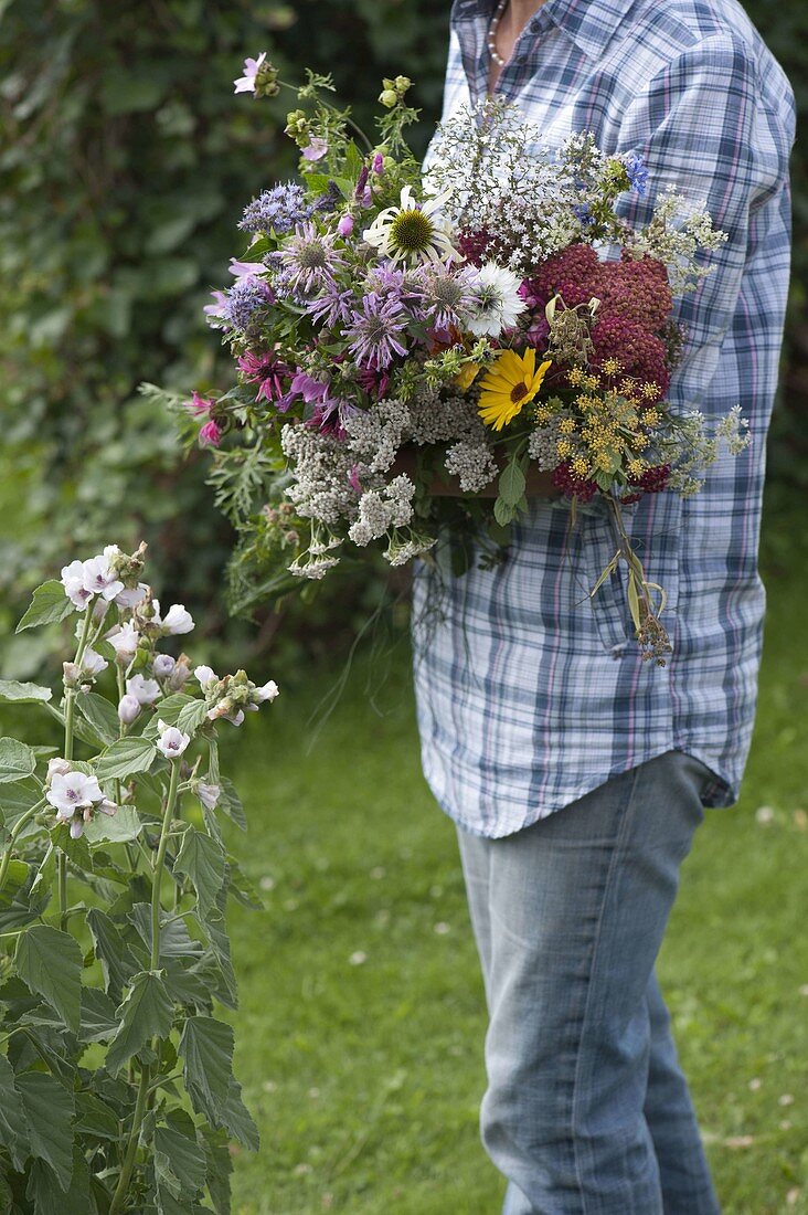 Woman with freshly cut cottage garden bouquet