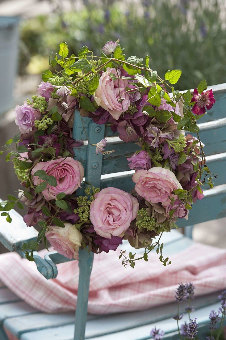 Wreath with pink 'Cream Gracia' (roses), Clematis viticella 'Avant-Garde'.