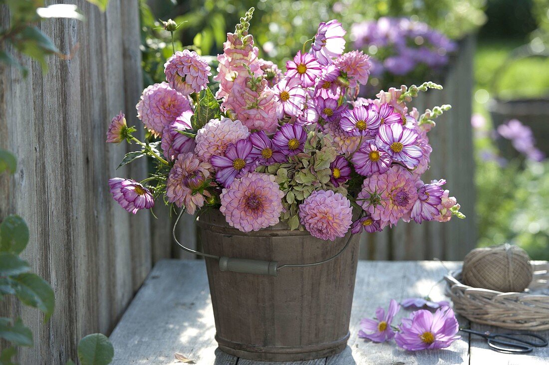 Pink-pink bouquet in wooden bucket