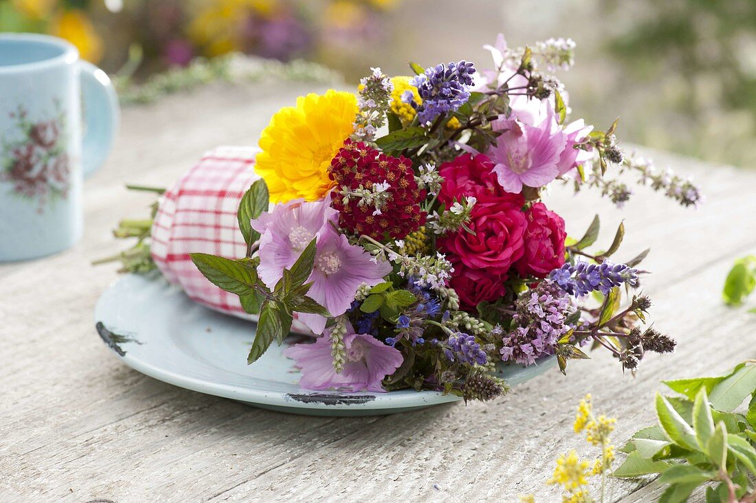 Bouquet of tea and medicinal herbs as a gift with red and white tea towel