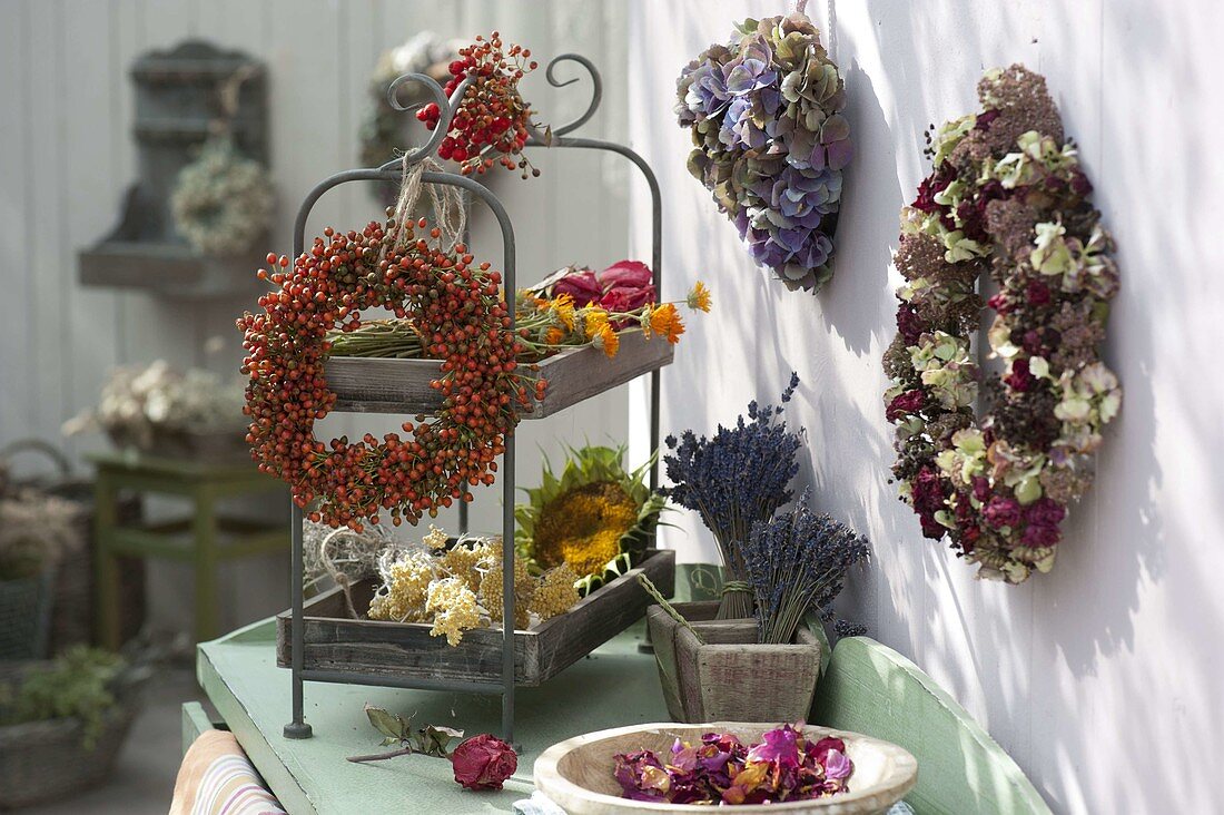 Wreath of pink (rosehip) hung on a shelf, heart of hydrangea