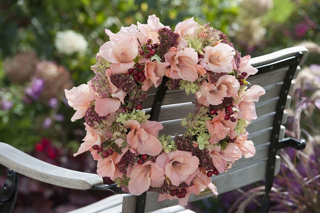 Wreath with pinned gladiolus, sedum and hydrangea