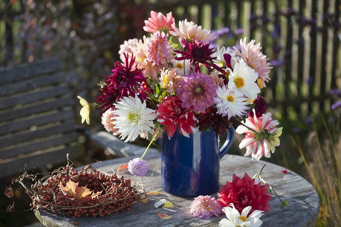 Bouquet of mixed Dahlia (dahlias) in blue jug and wreath