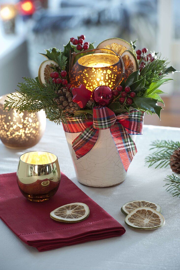 Candle arrangement with Ilex (holly) with red berries, Chamaecyparis