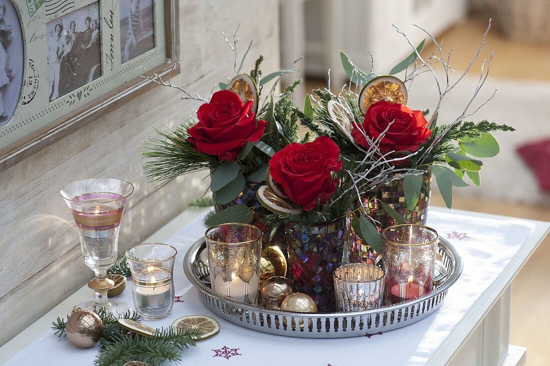 Christmas decoration with Rosa 'Orange Sky' (roses), Eucalyptus, Juniperus