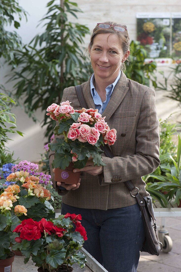 Woman buying flowers at garden centre