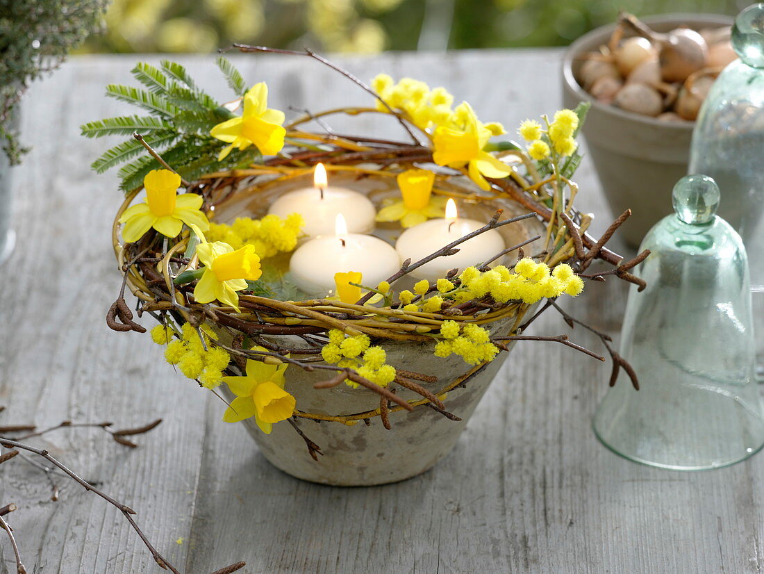 Floating candles in conical bowl with wreath of Salix branches