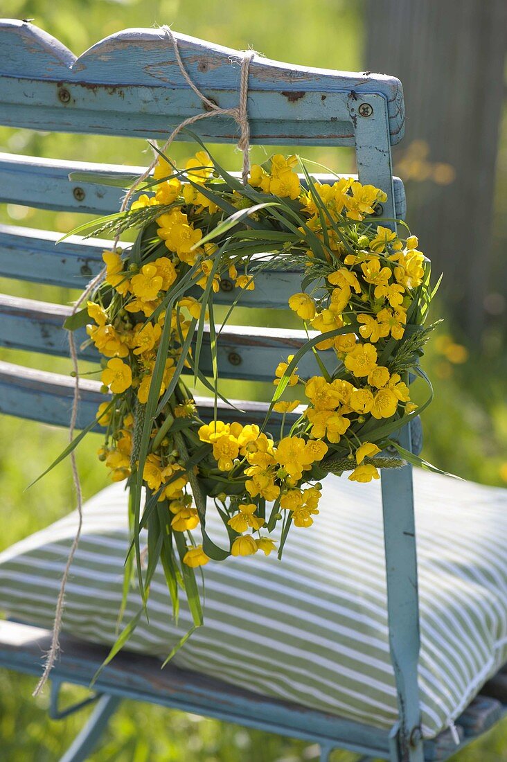 Wreath of grasses and Ranunculus (buttercups)