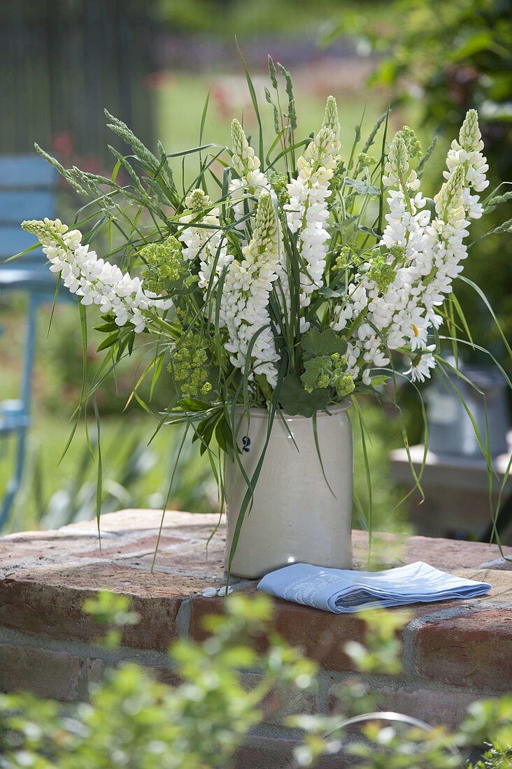 White bouquet of Lupinus (lupines), Alchemilla (lady's mantle) and grasses