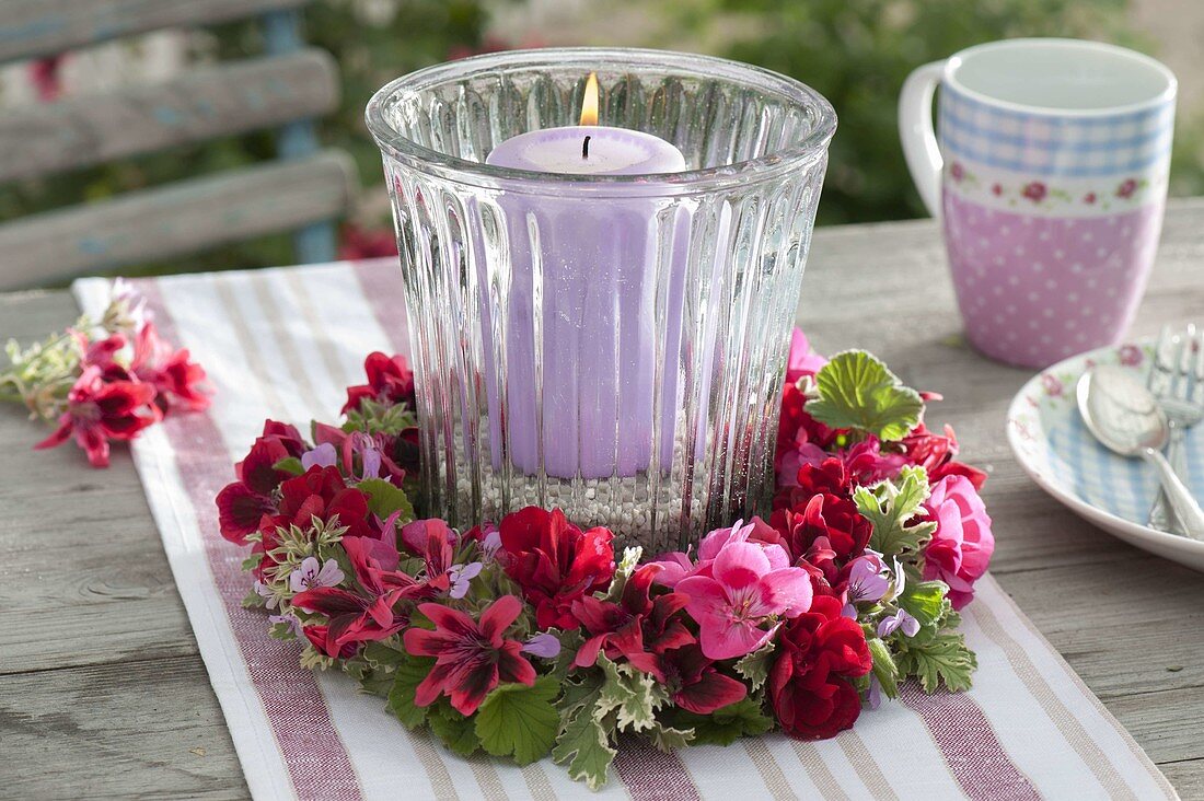 Lantern with wreath of pelargonium (geranium) flowers and leaves