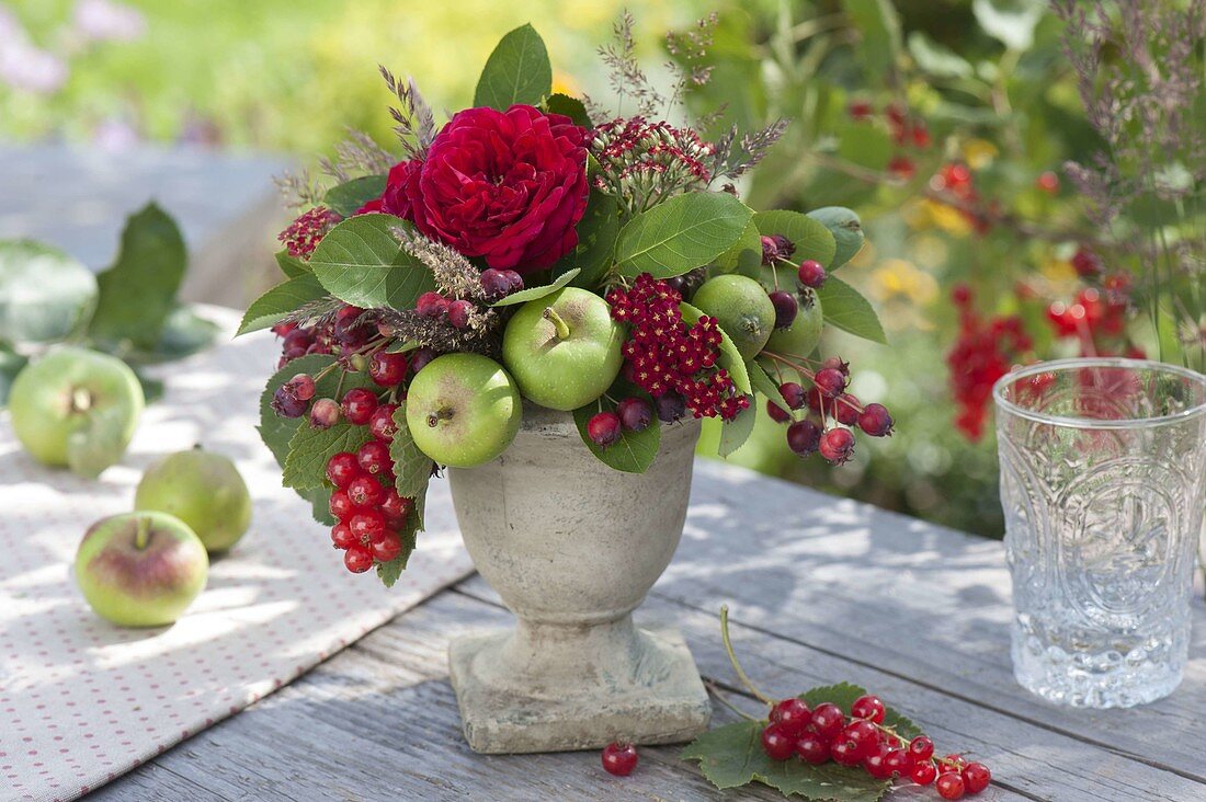 Rose-fruit arrangement in vase with foot